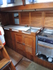 Galley includes refrigeration and freezer space, with twin sink, gimbled propane stove with oven, hot and cold pressure water and fresh water hand pump 